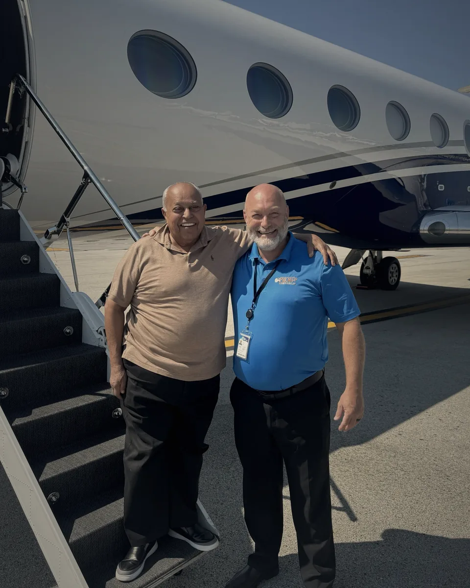Freddy, founder of Fredde Limousine, at the airstair of a private jet